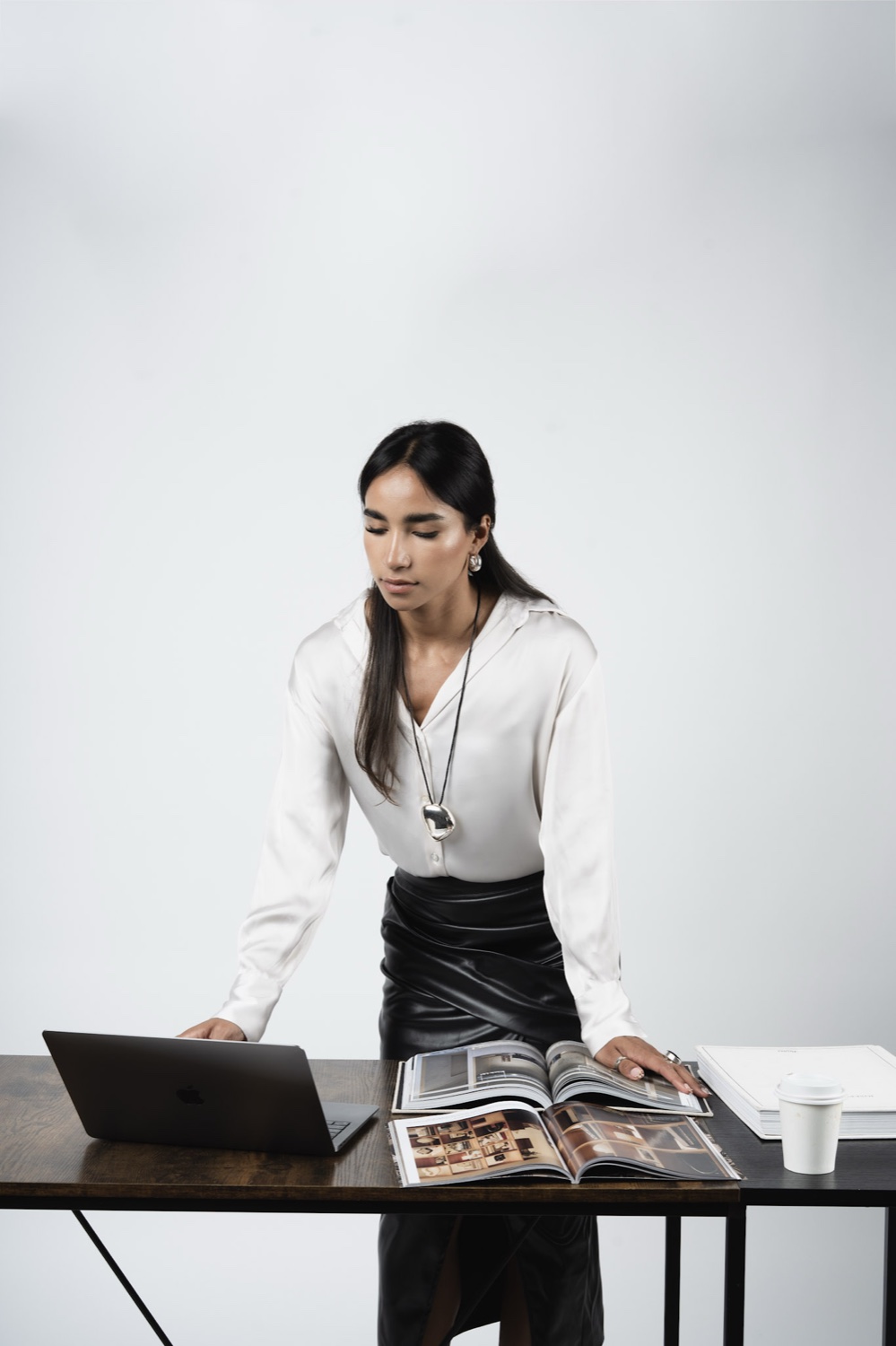 Karla Carrillo revisando un proyecto sobre una mesa de trabajo.